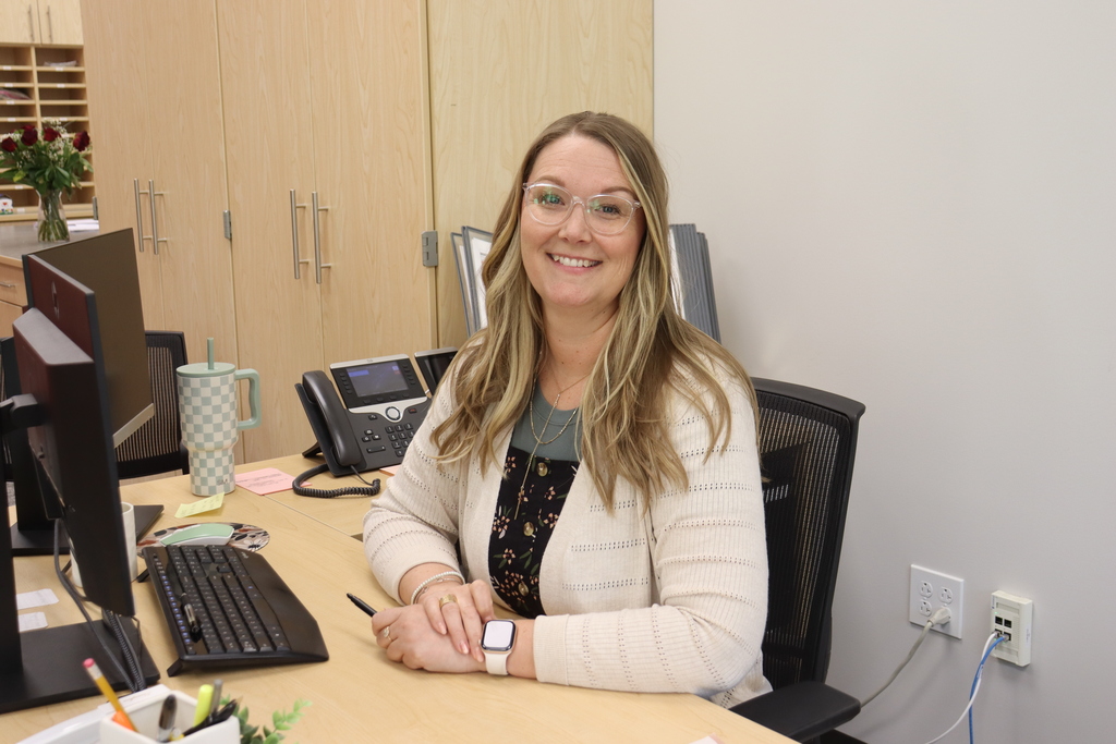 Admin. Assistant sitting at her desk