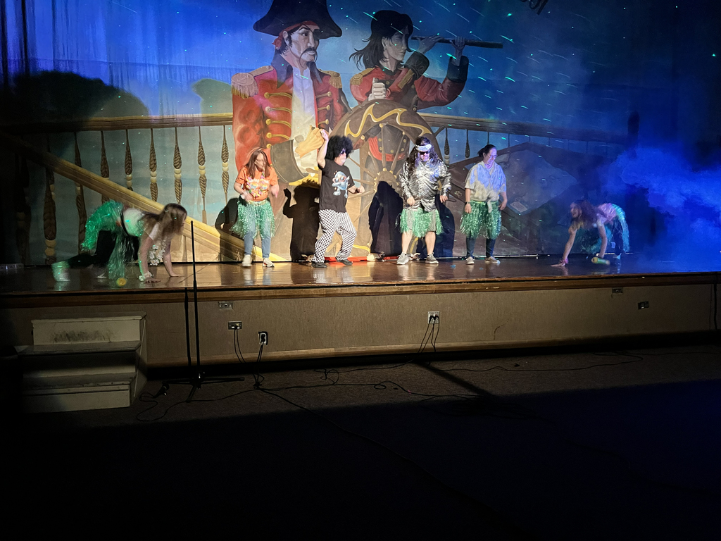 4 staff members dancing