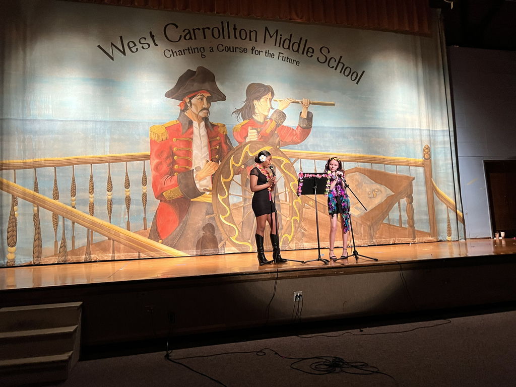 2 girls on stage emceeing the talent show