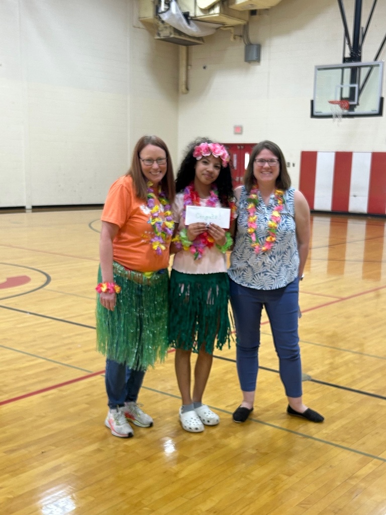 Girl standing between her teachers