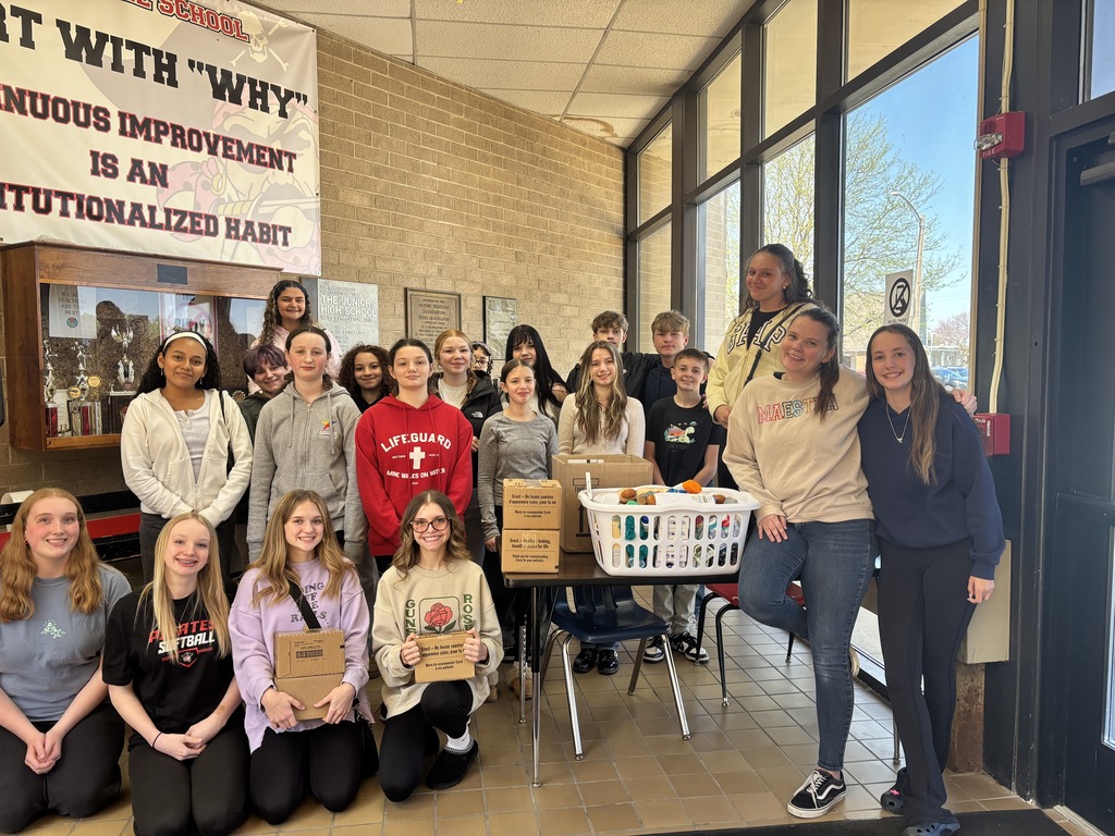 Group of people standing in a school foyer