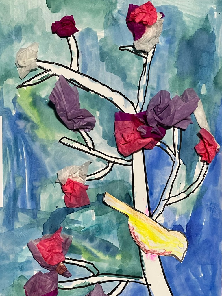 Abstract art with tree branches and flowers made from paper. Background is blue with green and white.