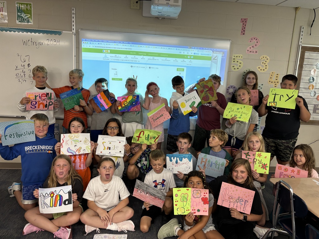 Picture of 5th grade students holding a picture they drew of the word they chose to focus on this year.