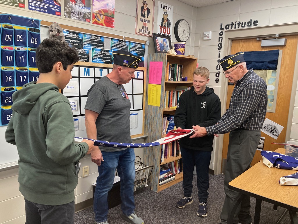 Students folding a flag.