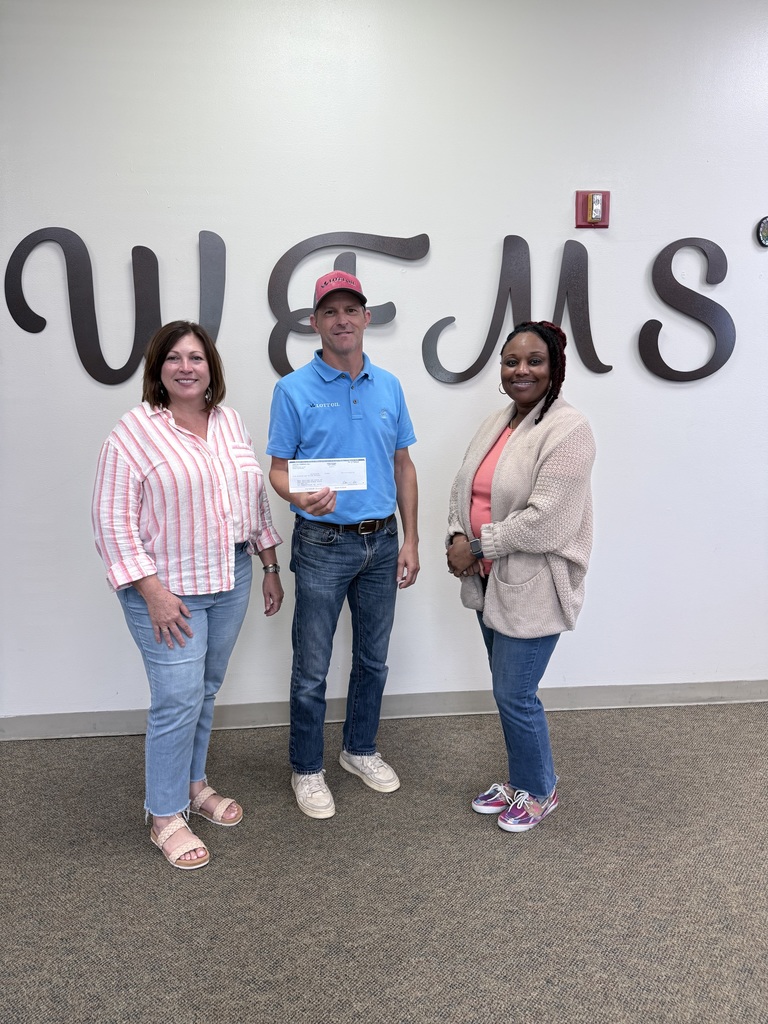 Administrators accept check from representative from Lott Oil Company