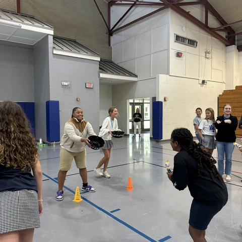 Students play a game at the meeting.