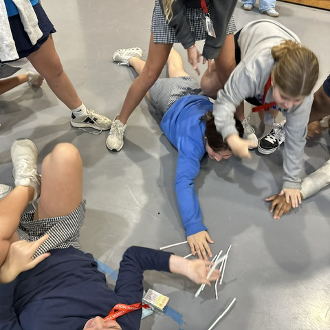 Students play a game at the meeting.