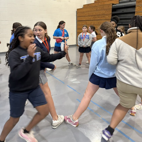 Students play a game at the meeting.