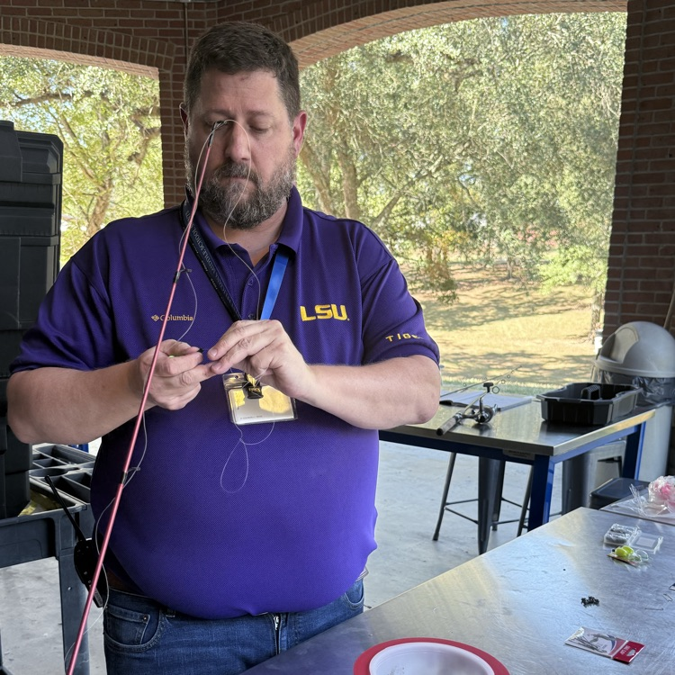 mr. Lester puts bait on a fishing pole