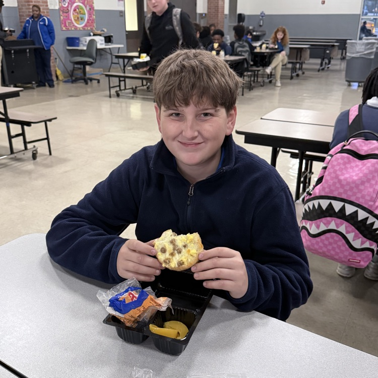 Student smiling with bagel