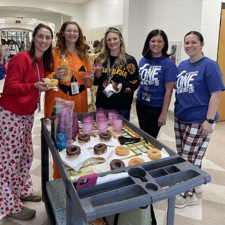 staff members enjoy coffee and a doughnut