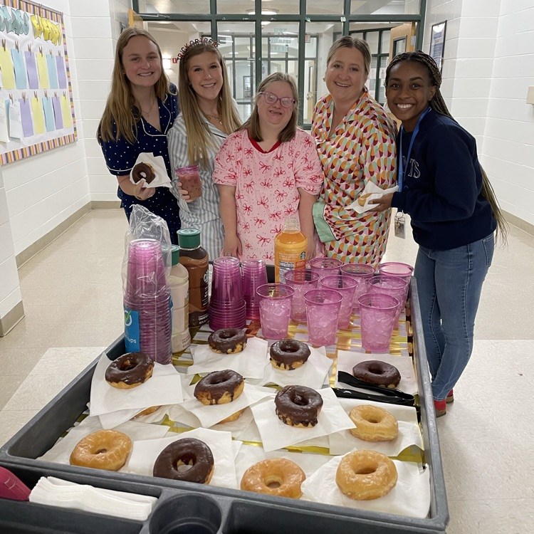 staff members and enjoy coffee and a doughnut
