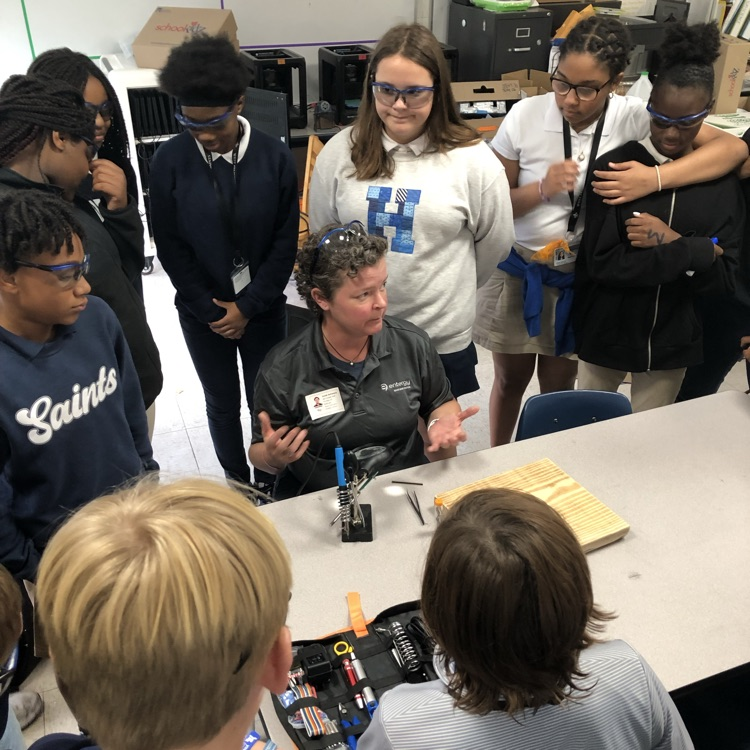 Volunteers from Entergy work with students