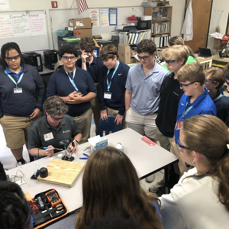 Volunteers from Entergy work with students