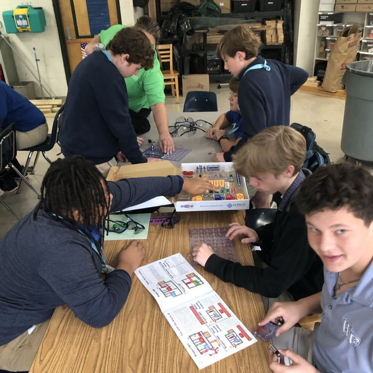 Volunteers from Entergy work with students