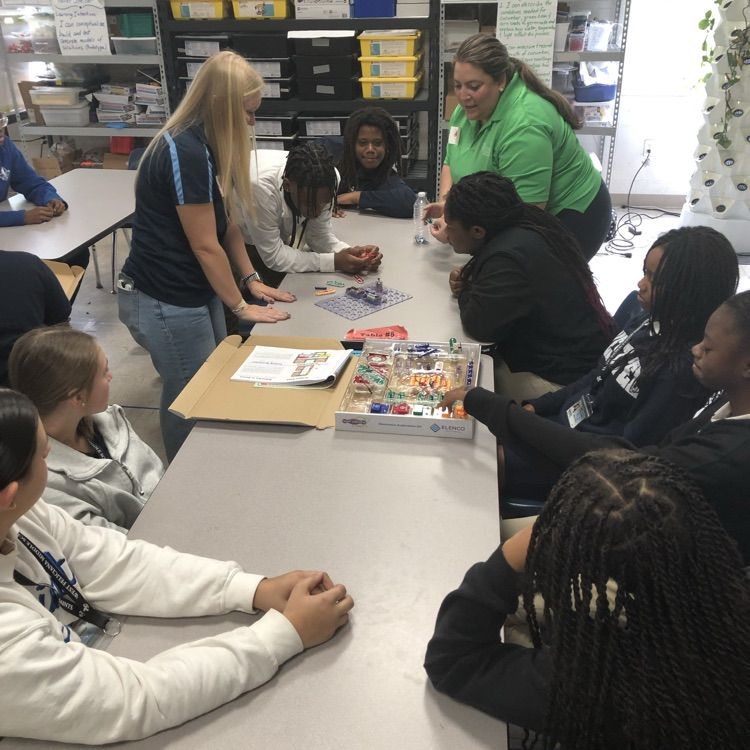 Volunteers from Entergy work with students