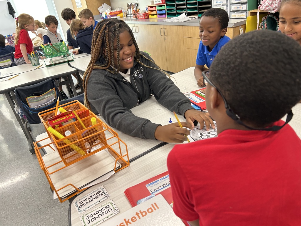 8th graders help elementary students with math.