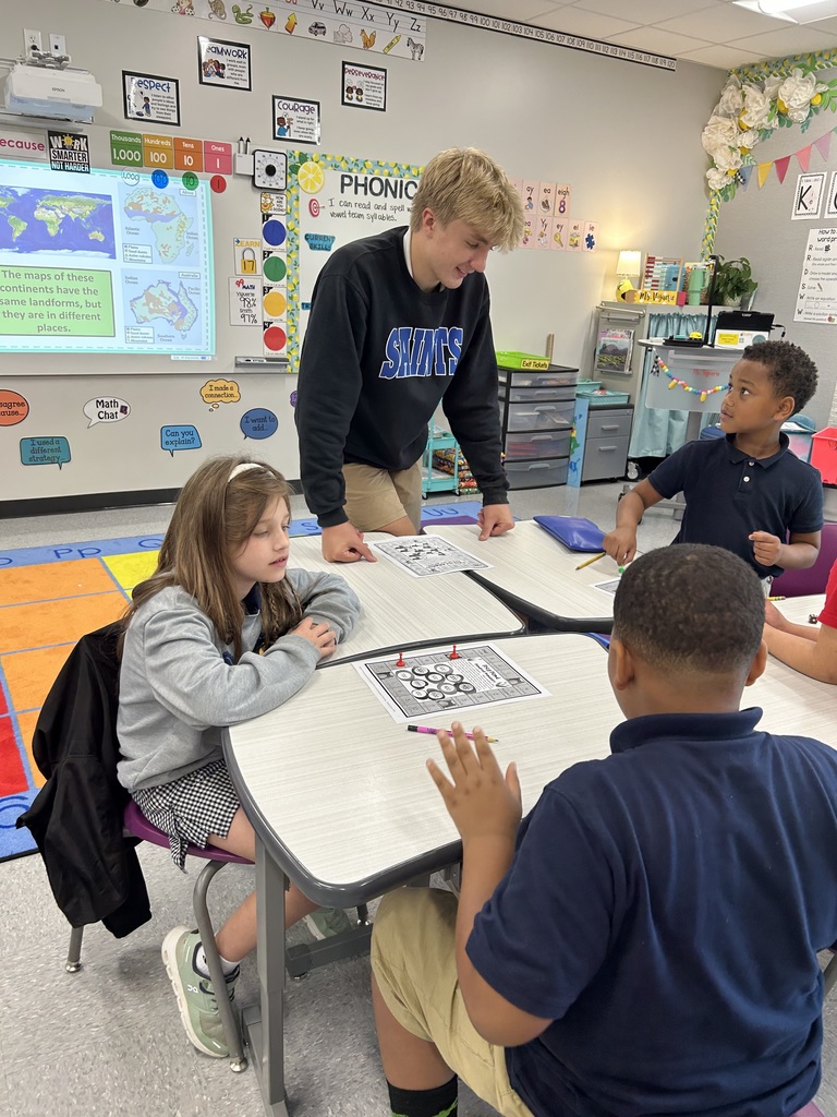 8th graders help elementary students with math.