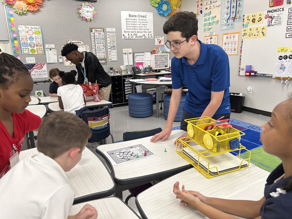 8th graders help elementary students with math.