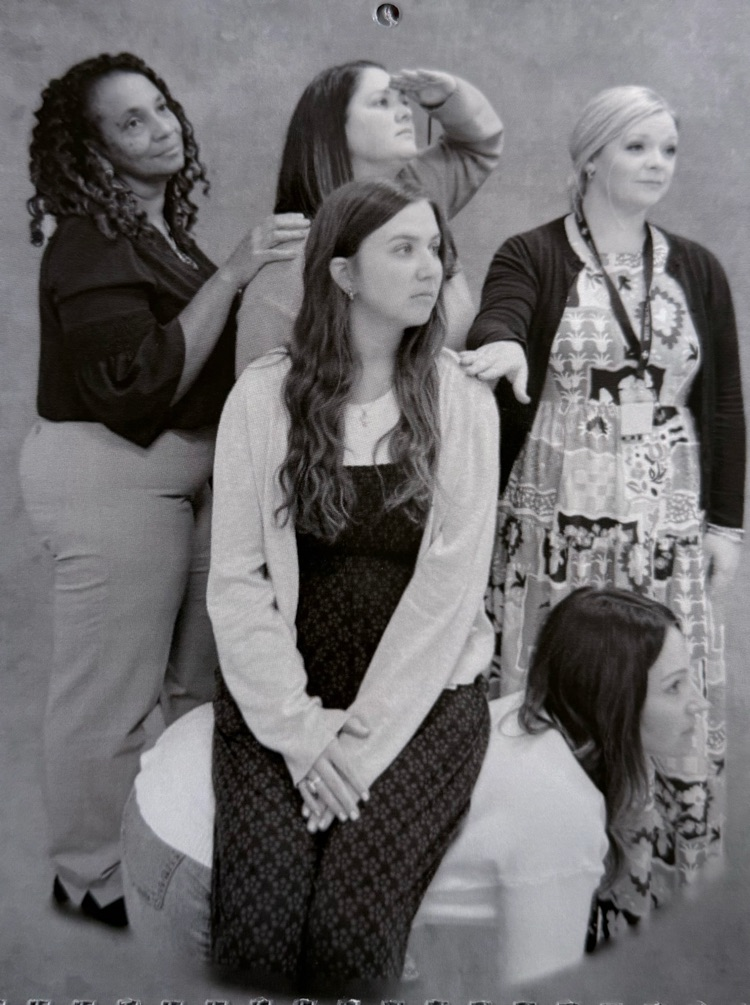 Staff members pose for classic photo shoot