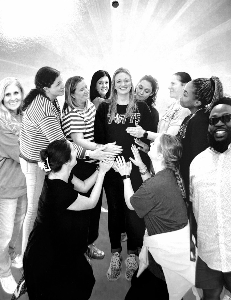 Staff members pose for classic photo shoot