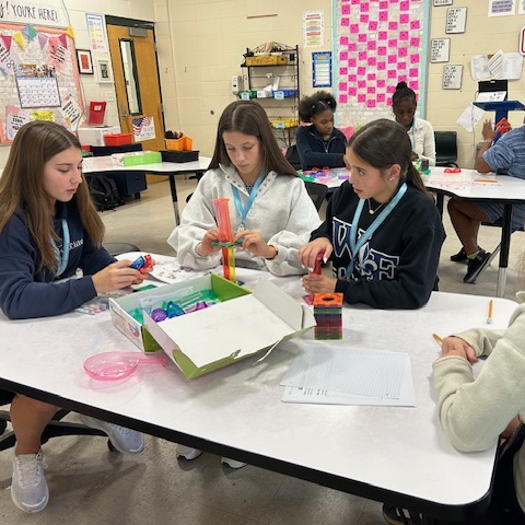 Students create marble run puzzles. 