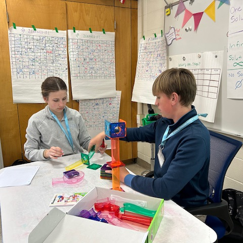 Students create marble run puzzles. 