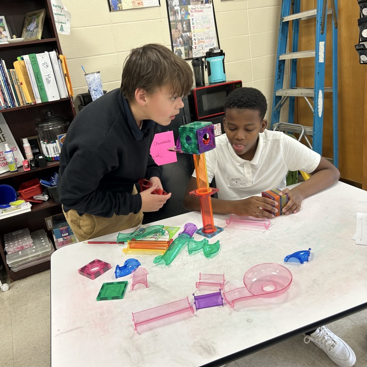 Students create marble run puzzles. 