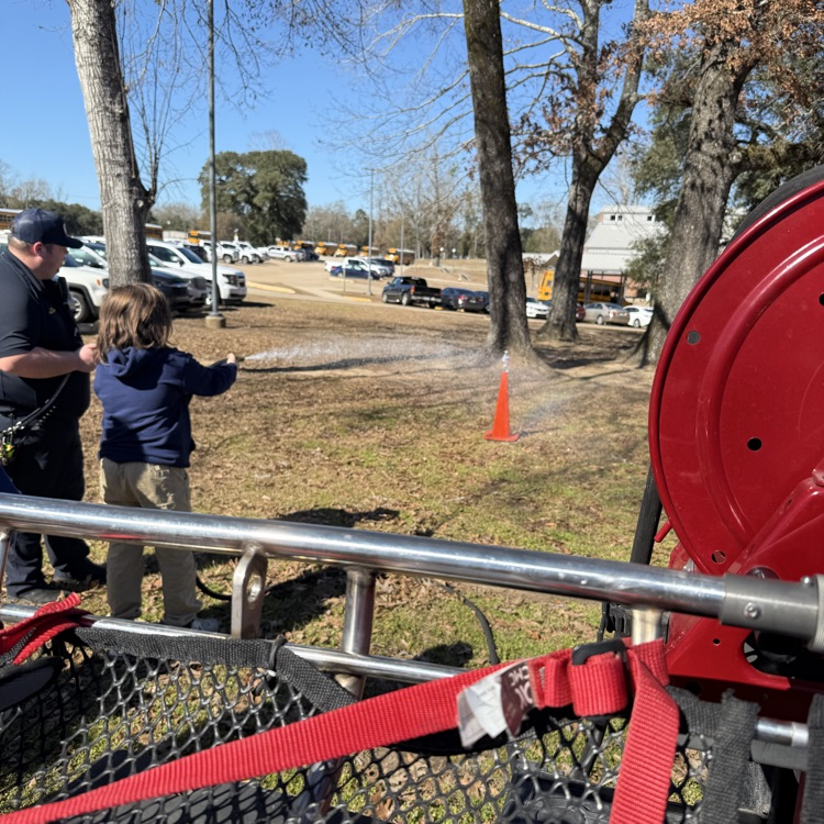 student uses fire hose