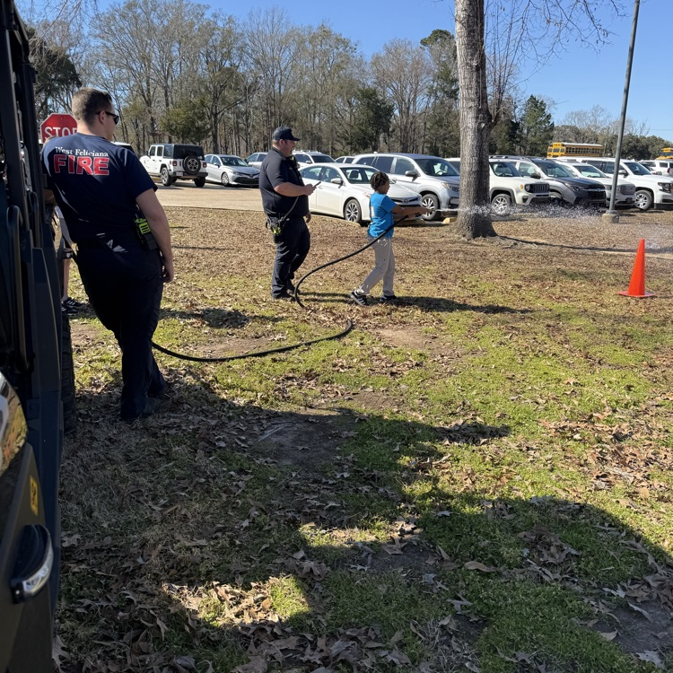 student uses fire hose