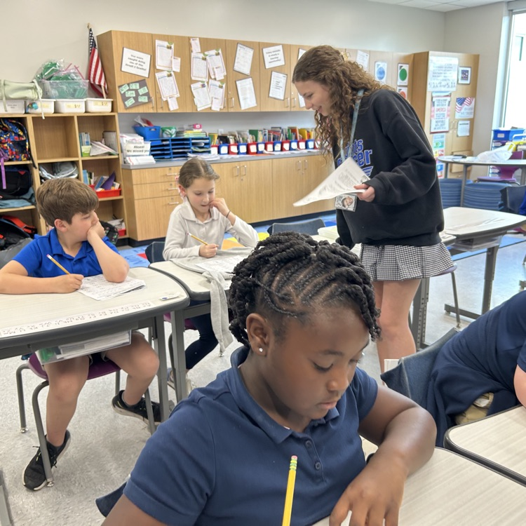 8th graders help elementary students with math problems 