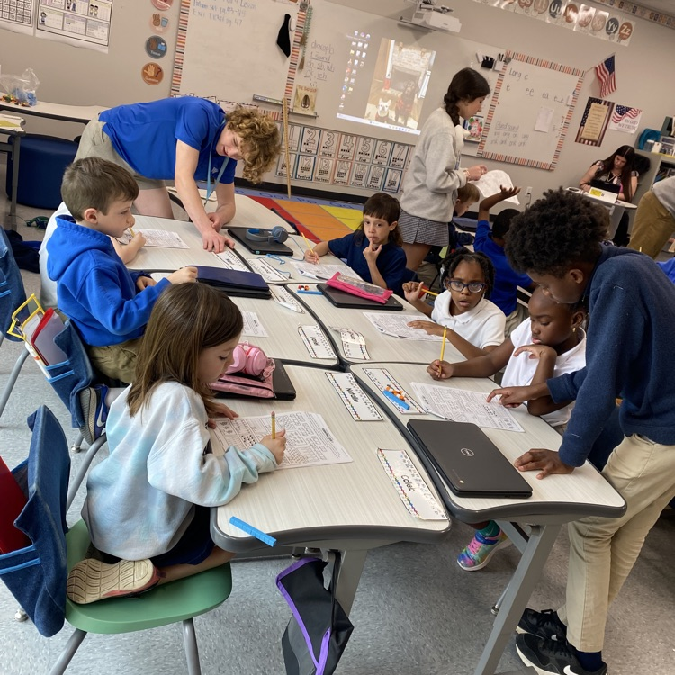 8th graders help elementary students with math problems 