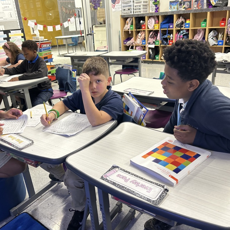 8th graders help elementary students with math problems 