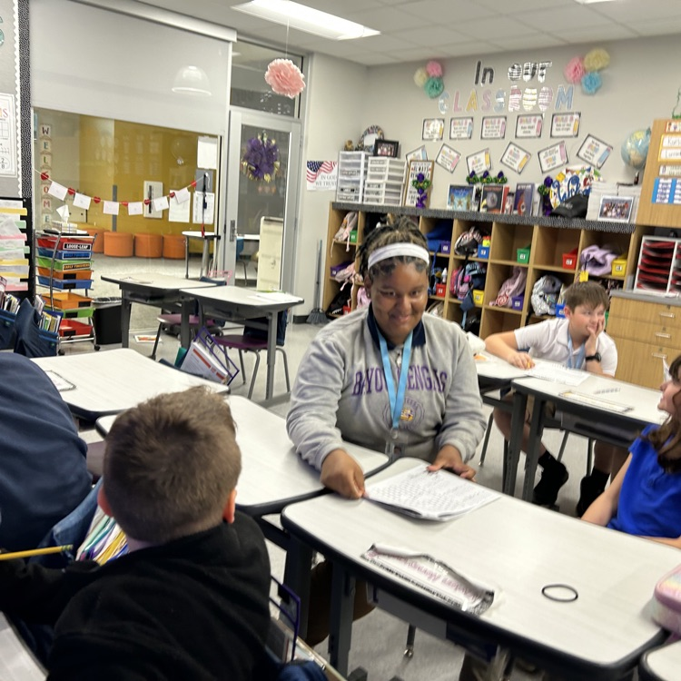 8th graders help elementary students with math problems 