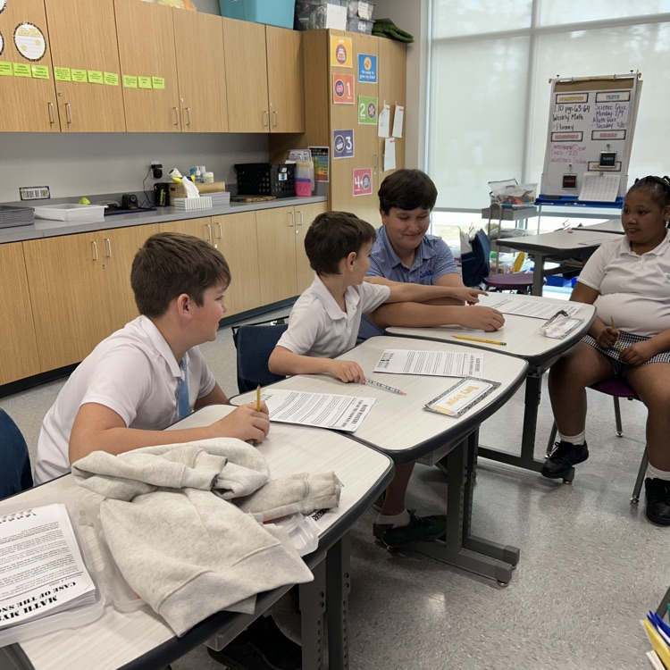 8th graders help elementary students with math problems 