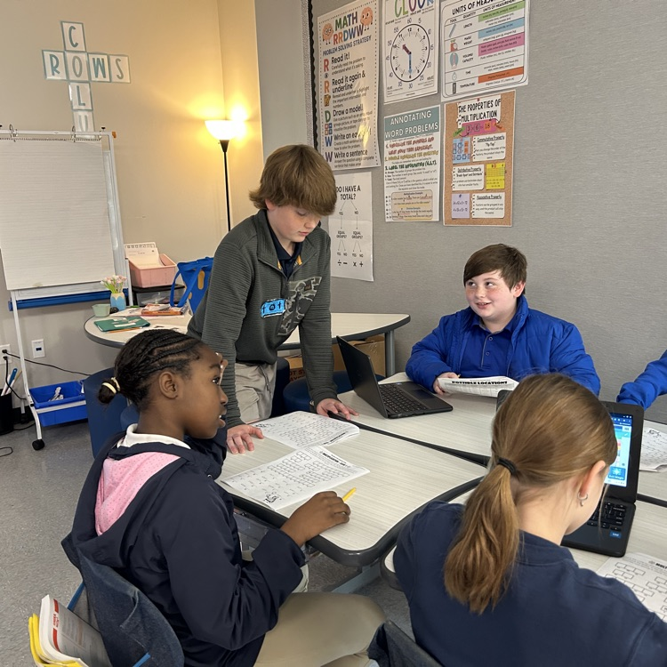 8th graders help elementary students with math problems 