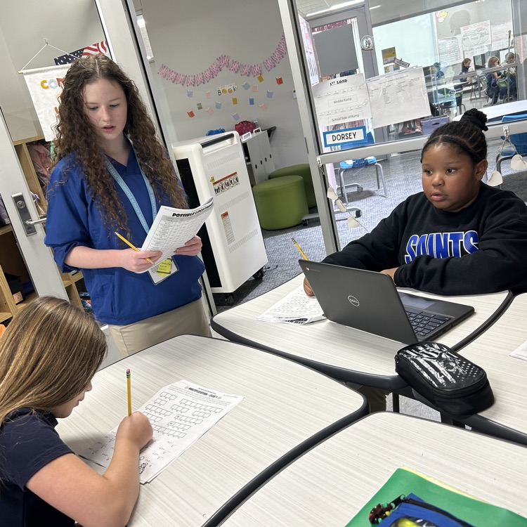 8th graders help elementary students with math problems 