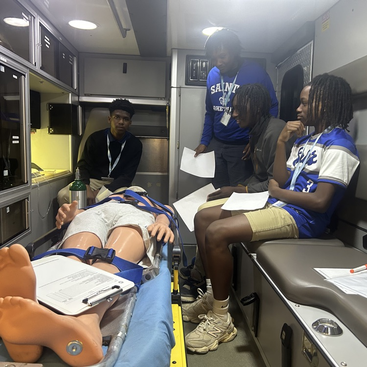 students see the back of an ambulance that is part of a first responders program