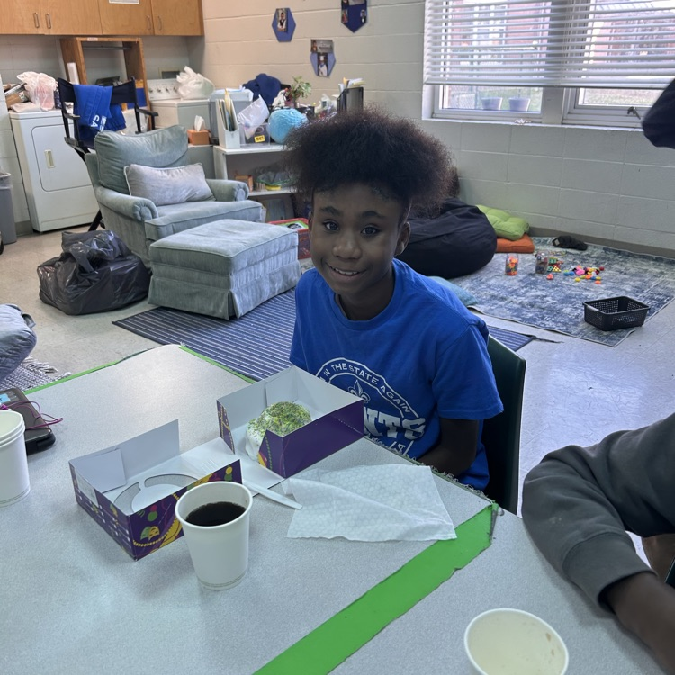 student shows off King cake 