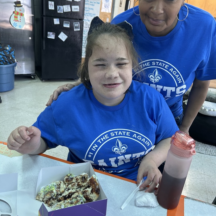 student shows off King cake 