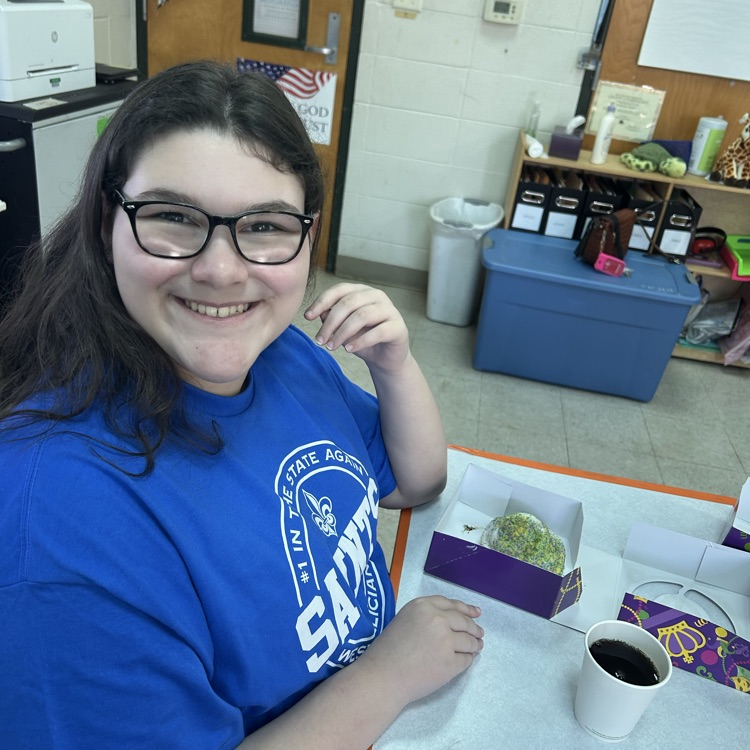 student shows off King cake 