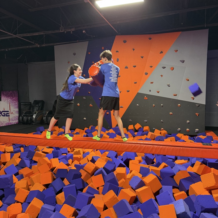 students battle it out in a foam pit