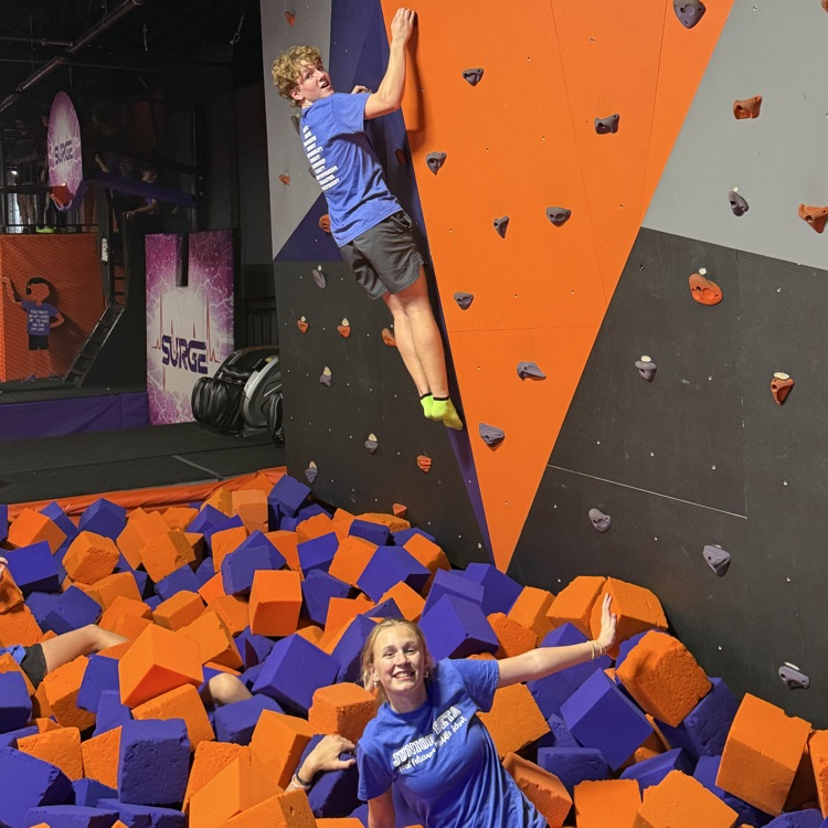 students on a rock climbing wall