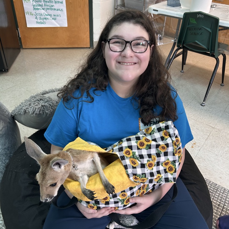 student hold a baby kangaroo