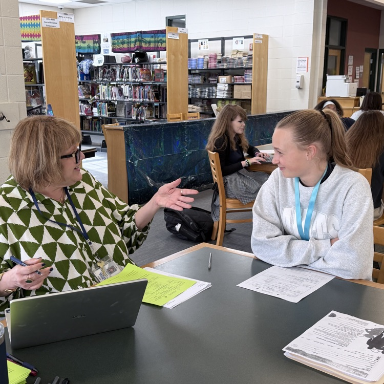 student meets with high school counselor