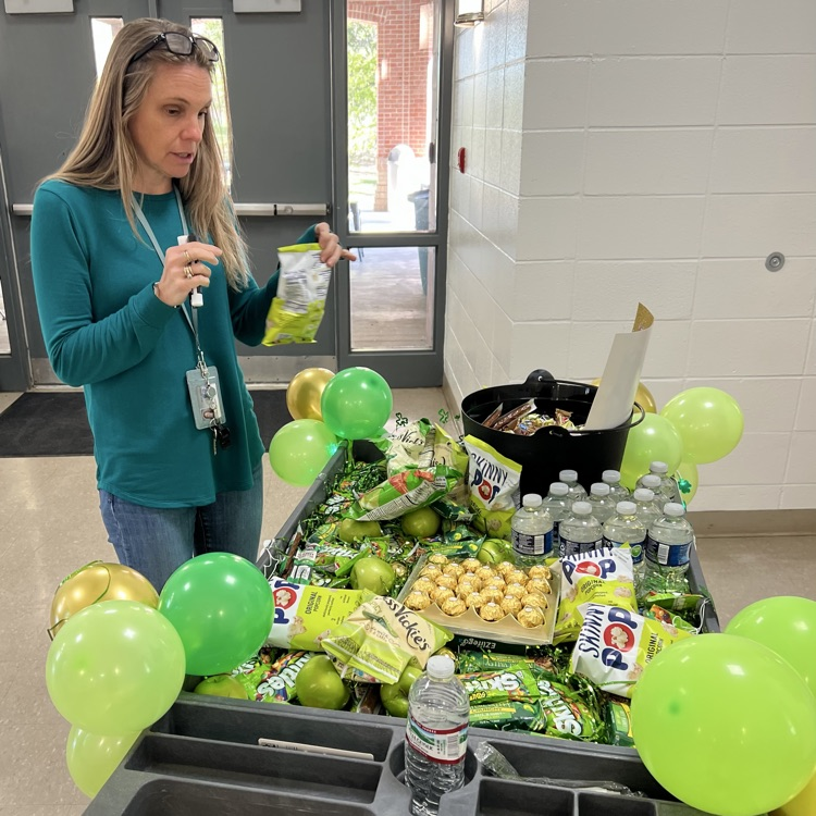 Teachers choose a treat off the cart. 