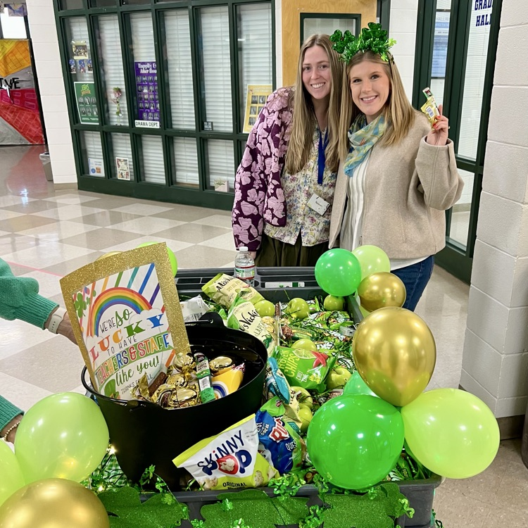 Teachers choose a treat off the cart. 