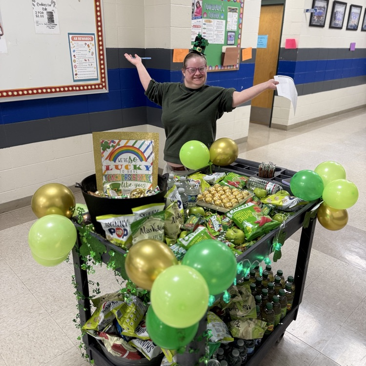Mary chooses a treat off the cart. 
