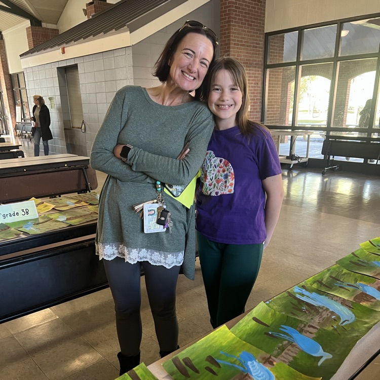 Student shows her mom artwork 