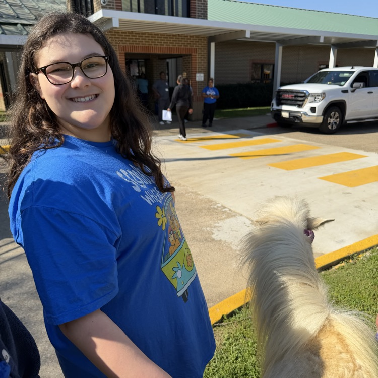 student petting a pony